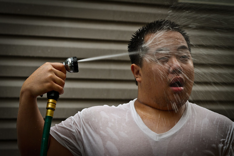 a person splashing water on themselves 